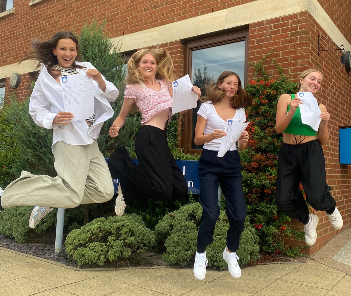 girls from Northampton High School GDST jumping for joy following their GCSE results