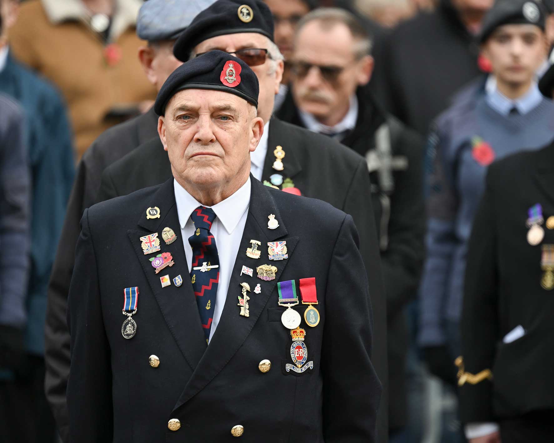 Veterans marching in Northampton’s Remembrance Sunday parade wearing military medals and berets.
